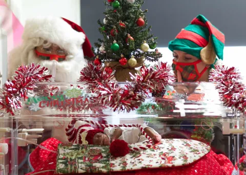 NICU Baby Visited by Santa and Santa's Friends